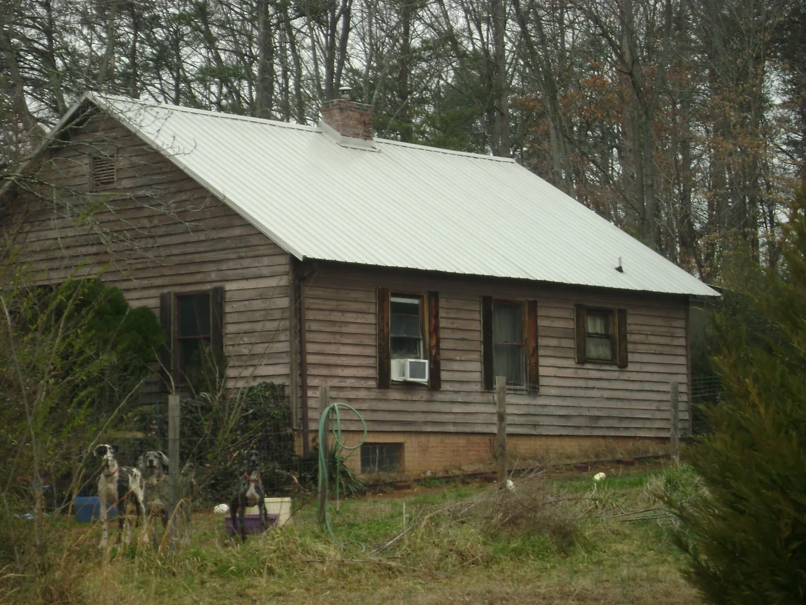 White metal roof on an old wood sided farmhouse, from a Metal Roof Installation job in Glasford